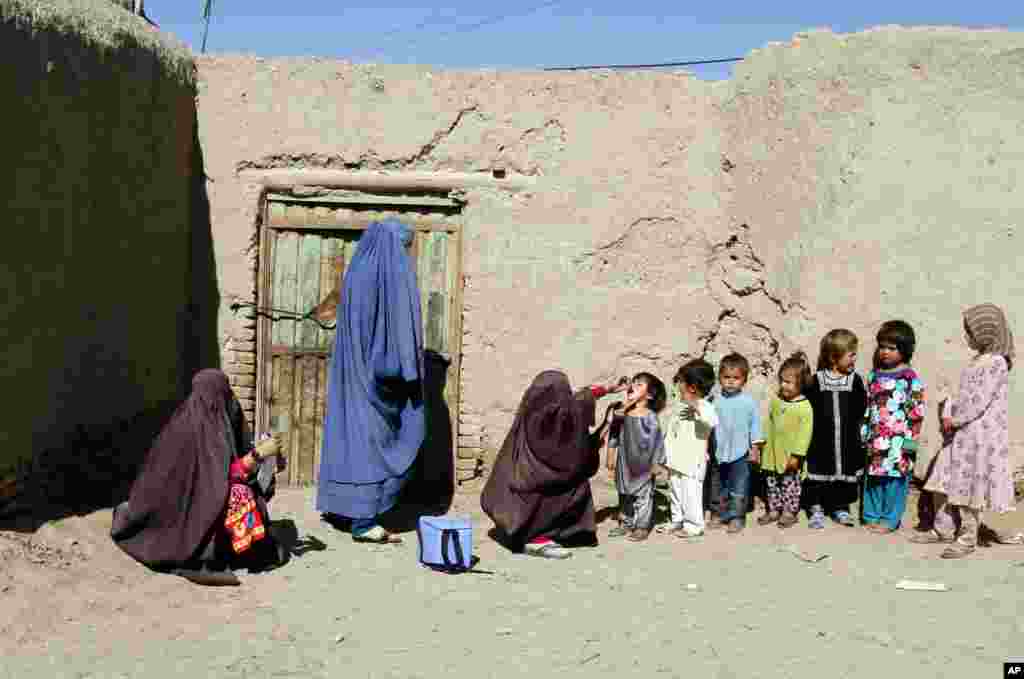 An Afghan health worker gives a vaccination to a child during a polio campaign in Kandahar, south of Kabul.