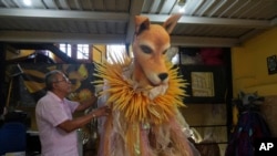 Workshop director Roberto Gomes inspects a caramelo dog costume at the Sao Clemente samba school, whose 2025 Carnival theme is animal abuse and abandonment, in Rio de Janeiro, Nov. 28, 2024.