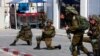 Israeli soldiers work to secure residential areas following a mass-infiltration by Hamas gunmen from the Gaza Strip, in Sderot