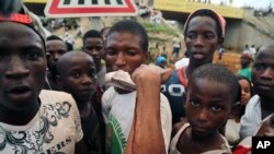 A man shows on his arm where he was injured at a rally in support of UFDG presidential candidate Cellou Dalein Diallo in Conakry, Guinea, Oct. 8, 2015.