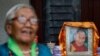 A Tibetan woman dressed in traditional attire stands near the portrait of Dalai Lama during a function organized to mark his 86th birthday celebration in Lalitpur, Nepal, on July 6, 2021. Navesh Chitrakar/Reuters 