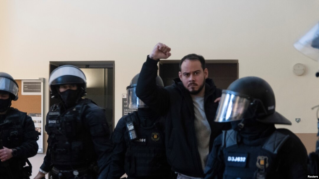 Spanish rapper Pablo Hasel reacts as he is detained by riot police inside the University of Lleida, after he was sentenced to jail time on charges including insulting the monarchy and glorifying terrorism, in Lleida, Spain, Feb. 16, 2021. 