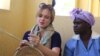 Assistant Professor, Jeanne-Marie Jackson of Johns Hopkins University, USA, learning from a local villager how to weave s basket at Amagugu International Heritage Center. (Photo: Amagugu)
