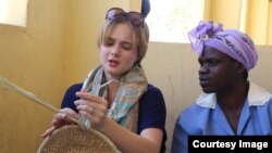 Assistant Professor, Jeanne-Marie Jackson of Johns Hopkins University, USA, learning from a local villager how to weave s basket at Amagugu International Heritage Center. (Photo: Amagugu)