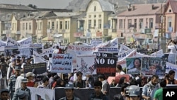 Afghan people take part in an anti U.S. rally organized by ' Afghanistan Hambastegi' party in Kabul, Afghanistan, Oct. 6, 2011.