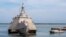 A Naval Station vessel, right, prepares to assist the future USS Omaha (LCS 12), a 218-foot-long littoral combat ship, pier side during a brief fuel stop in Guantanamo Bay, Cuba, Jan. 3, 2018. The Omaha was conducting a change of homeport to San Diego, Calif.