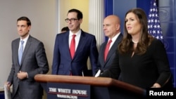 Homeland security adviser Tom Bossert, U.S. Treasury Secretary Steve Mnuchin, national security adviser H.R. McMaster and White House press secretary Sarah Huckabee Sanders arrive at a news briefing at the White House in Washington to announce sanctions against Venezuela, Aug. 25, 2017.