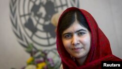 Pakistani activist Malala Yousafzai poses for pictures during a photo opportunity at the United Nations in New York, Aug. 18, 2014. 