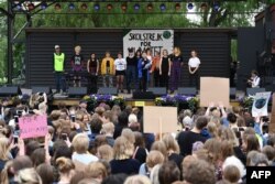 FILE - Greta Thunberg, center, the 16-year-old Swedish climate activist, speaks at an event during a global day of student protests aiming to spark world leaders into action on climate change in Stockholm, Sweden, May 24, 2019.