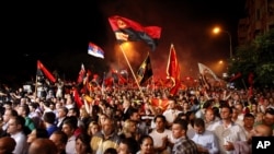 Supporters of the ruling conservative VMRO-DPMNE party rally in front of the Parliament building in Skopje, Macedonia, 18, 2015. 