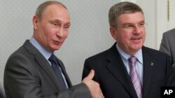 FILE - Russian President Vladimir Putin (L) and International Olympic Committee President Thomas Bach meet at the Bocharov Ruchei residence at the Black Sea resort of Sochi, southern Russia, Oct. 28, 2013.