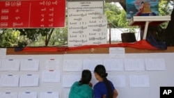 Prospective voters check eligible voters' list at an administrative office in Mandalay.