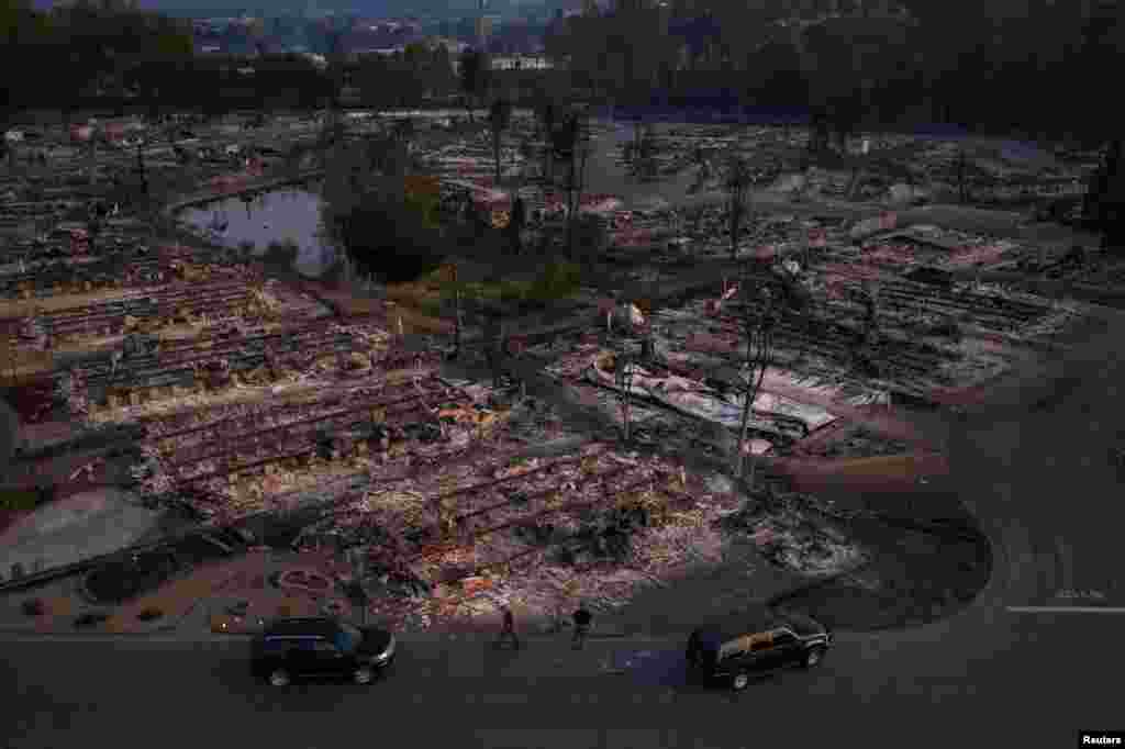 Security officials survey the Bear Lakes Estates neighborhood, which was devastated by the Almeda Fire in Phoenix, Oregon, Sept. 9, 2020.