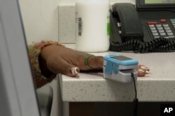 FILE—Jazmin Evans, a student at Temple University, has readings taken during a checkup at Jefferson Health in Philadelphia on February 16, 2024.