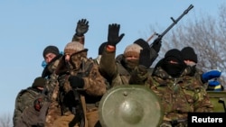 FILE - Members of the Ukrainian armed forces ride on a military vehicle near Debaltseve, eastern Ukraine, Feb. 17, 2015.