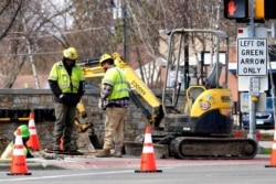 Construction workers work in Wheeling, Ill., March 31, 2021. President Joe Biden on Wednesday unveiled his $2 trillion infrastructure plan aimed at revitalizing U.S. transportation infrastructure, water systems, broadband and manufacturing.