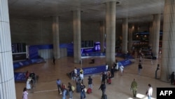 FILE - Travelers walk through a main hall at Israel's Ben Gurion airport near Tel Aviv on Nov. 6, 2024.