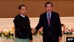 Hun Sen bắt tay tướng Min Aung Hlaing (trái) tại Naypyidaw. (Photo by An Khoun SamAun / National Television of Cambodia (TVK) / AFP)