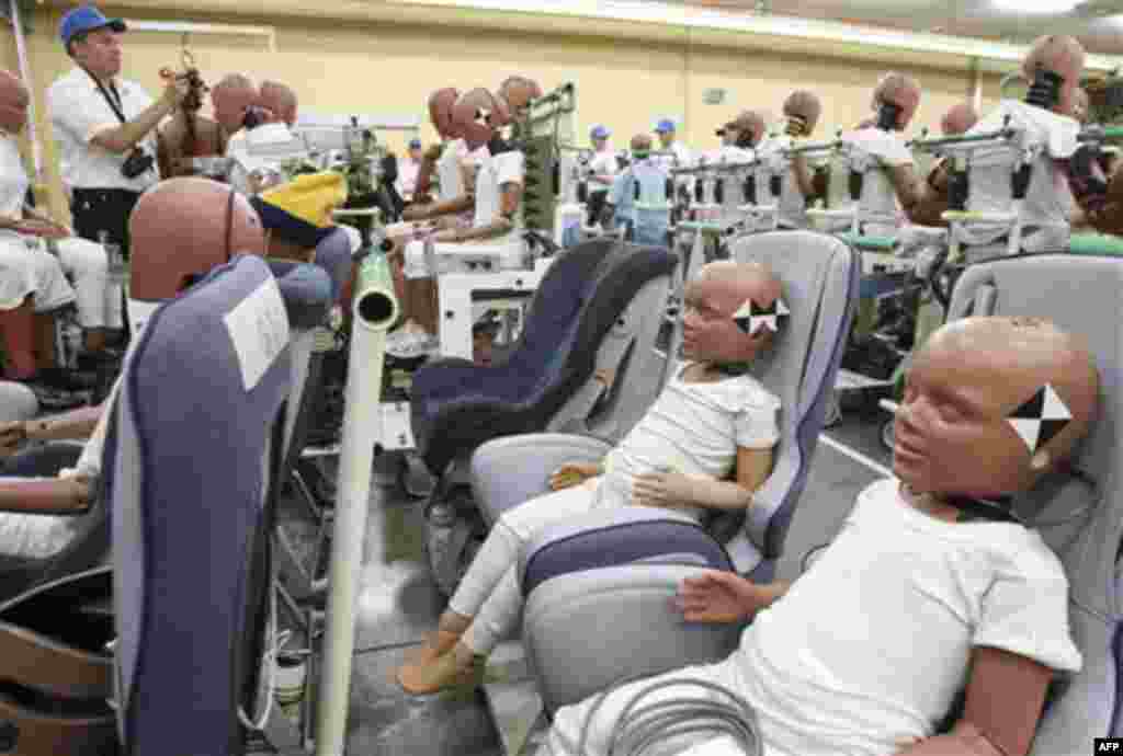 A photographer takes a picture of dummies in a demonstration of Toyota Motor Corp.'s safety technology at its facility in Susono near Mount Fuji, west of Tokyo, Japan, Thursday, July 21, 2011. (AP Photo/Koji Sasahara)