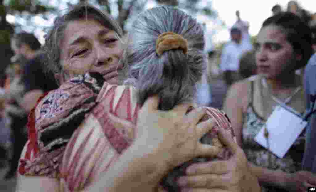 Relatives of victims killed during Argentina's dirty war embrace at the end of the trial of former dictator Jorge Videla in Cordoba, Argentina, Wednesday Dec. 22, 2010. Videla was sentenced to life in prison Wednesday for the torture and murder of 31 pri