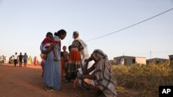 Ethiopian refugees gather in Qadarif region, easter Sudan, Monday, Nov. 16, 2020. The U.N. refugee agency says Ethiopia's growing conflict has resulted in thousands fleeing from the Tigray region into Sudan as fighting spilled beyond Ethiopia's borders and threatened to inflame t