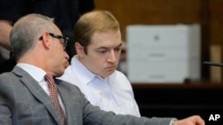 James Jackson, right, confers with his lawyer during a hearing in criminal court in New York, Jan. 23, 2019.