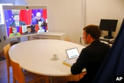 French President Emmanuel Macron attends an EU-China videoconference with Chinese President Xi Jinping, German Chancellor Angela Merkel, European Commission President Ursula von der Leyen and European Council President Charles Michel, Dec. 30, 2020.