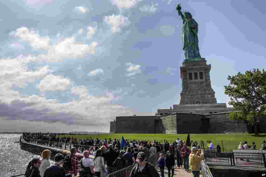 The Statue of Liberty looms over crowds of visitors on Liberty Island in New York Harbor, Sunday, Oct. 13, 2013, in New York. 