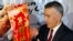 U.S. Ambassador to the Philippines Philip Goldberg, right, is presented a Chinese New Year scroll by journalist Wilson Flores during a forum Wednesday, Feb. 3, 2016 at suburban Quezon city, northeast of Manila, Philippines.