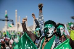 Supporters of Shi'ite rebels, known as Houthis, chant slogans as they attend a celebration of moulid al-nabi, the birth of Islam's prophet Muhammad in Sana'a, Yemen, Oct. 29, 2020.