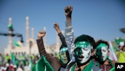FILE - Supporters of Shi'ite rebels known as Houthis chant slogans as they attend a celebration of moulid al-nabi, the birth of Islam's prophet Muhammad, in Sana'a, Yemen, Oct. 29, 2020.