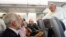 Pope Francis listens to journalist's question as he flies back to Rome following Brazil visit, July 29, 2013.