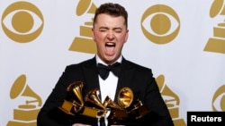Sam Smith holds his four Grammys in the press room at the Grammy Awards in Los Angeles, California, February 8. 