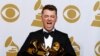 Sam Smith poses with his awards for Best New Artist, Best Pop/Vocal Album for "In the Lonely Hour" and Song of the Year and Record of the Year for "Stay With Me" in the press room at the 57th annual Grammy Awards in Los Angeles, California, Feb. 8, 2015. 