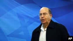 FILE - Israeli Defense Minister Moshe Yaalon arrives at the weekly cabinet meeting at the prime minister's Jerusalem office.