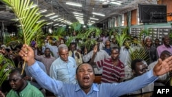 FILE - Believers pray without social distancing during a Palm Sunday mass at the Full Gospel Bible Fellowship Church in Dar es Salaam, Tanzania, April 5, 2020.