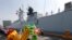 A dragon dance welcomes Wuhu, a Type 054A guided missile frigate from the Chinese Naval Task Group, as it docks at Manila's South Harbor for a four-day port call, Jan. 17, 2019 in Manila, Philippines.