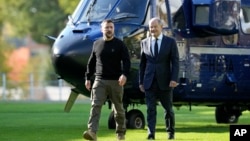 Ukraine's president Volodymyr Zelenskyy and German chancellor Olaf Scholz arrive for a meeting at the chancellery in Berlin, Germany, Oct. 11, 2024