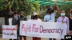 This handout photo taken and released by Dawei Watch on March 25, 2021 shows protesters holding banners as they take part in a demonstration against the military coup in Dawei. (Handout by Dawei Watch / AFP) 