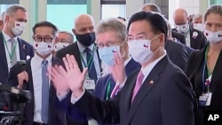In this image made from video, the Czech Senate President Milos Vystrcil, center, and Taiwan's Foreign Minister Joseph Wu, center right, wave at the Taoyuan International Airport, Aug. 30, 2020, in Taoyuan, Taiwan.