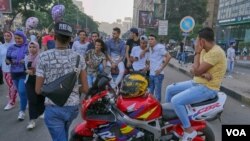 FILE - A group of young men make loud jokes while three girls walk by them in Cairo, Egypt, June 15, 2018. (Hamada Elrasam/VOA) 
