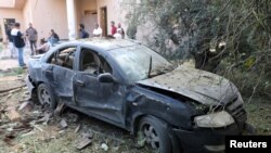 A damaged car is seen during clashes between rival factions in Tripoli, Libya, Aug. 30, 2018. 