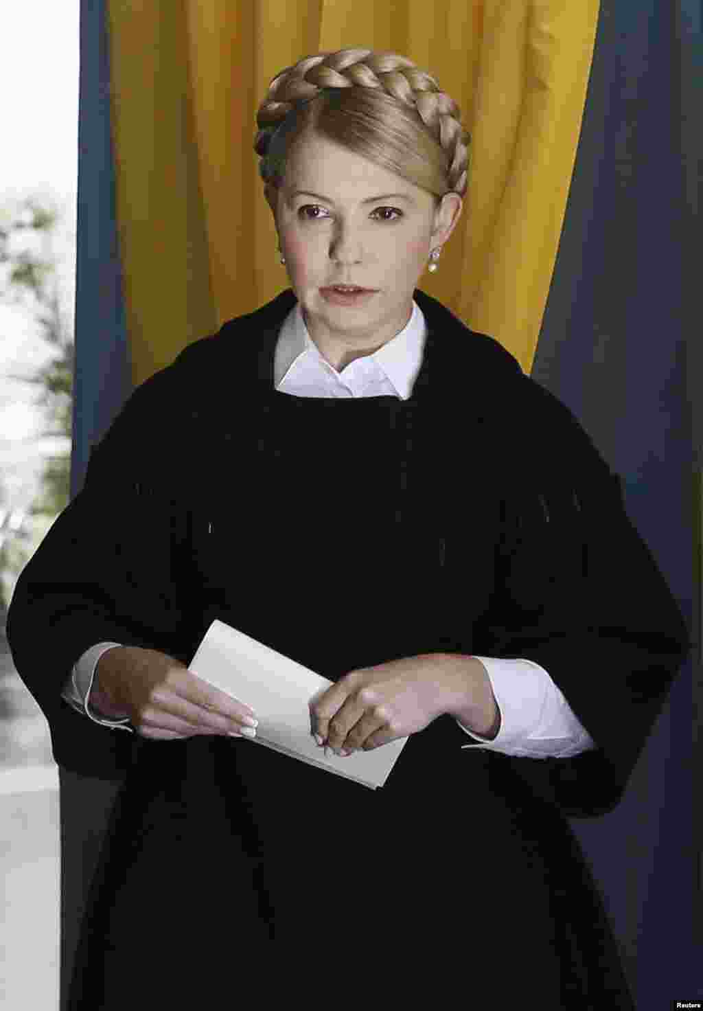 Former Ukrainian Prime Minister Yulia Tymoshenko, leader of the Batkivshchyna (Fatherland) party, holds a ballot at a polling station during a parliamentary election in Dnipropetrovsk, Oct. 26, 2014. 