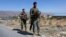 FILE - Lebanese army soldiers stand guard at an entrance to Arsal, a predominantly Sunni Muslim town near the Syrian border in eastern Lebanon, Aug. 4, 2014.