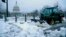 A worker clears snow from the sidewalks near the U.S. Capitol in Washington, March 17, 2014.