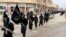 FILE - undated image posted on a militant website shows fighters from the al-Qaida linked Islamic State of Iraq and the Levant (ISIL) marching in Raqqa, Syria.