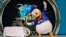 Popular Disney charactor Donald Duck gestures to a cake as he performs on the eve of his birthday during "Disney Magic" event in Bangalore, June 8, 2013. 