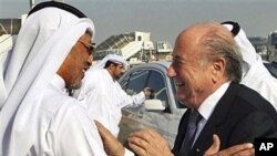 FIFA president Sepp Blatter (R) is greeted by AFC president Mohammed bin Hammam upon his arrival at the airport in Doha for an official visit to Qatar, 16 Dec 2010