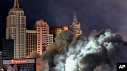 A dust cloud partially covers the New York-New York hotel-casino after the Tropicana Las Vegas towers were imploded, in Las Vegas, Oct. 9, 2024.