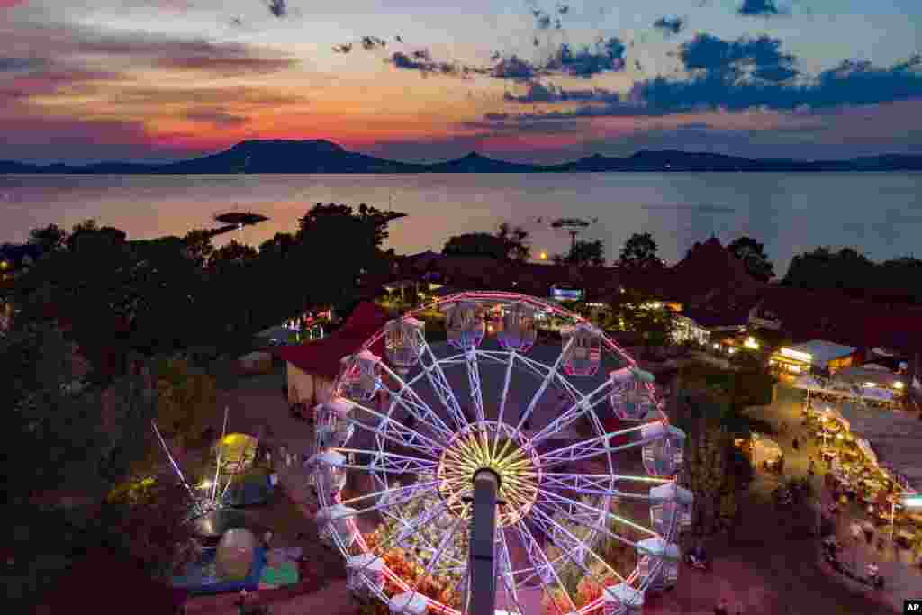 An illuminated Ferris wheel is seen during sunset at Fonyod, Hungary, July 25, 2019. (Gyorgy Varga/MTI)